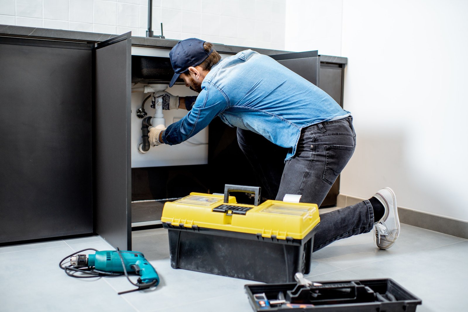 man-repairing-kitchen-furniture